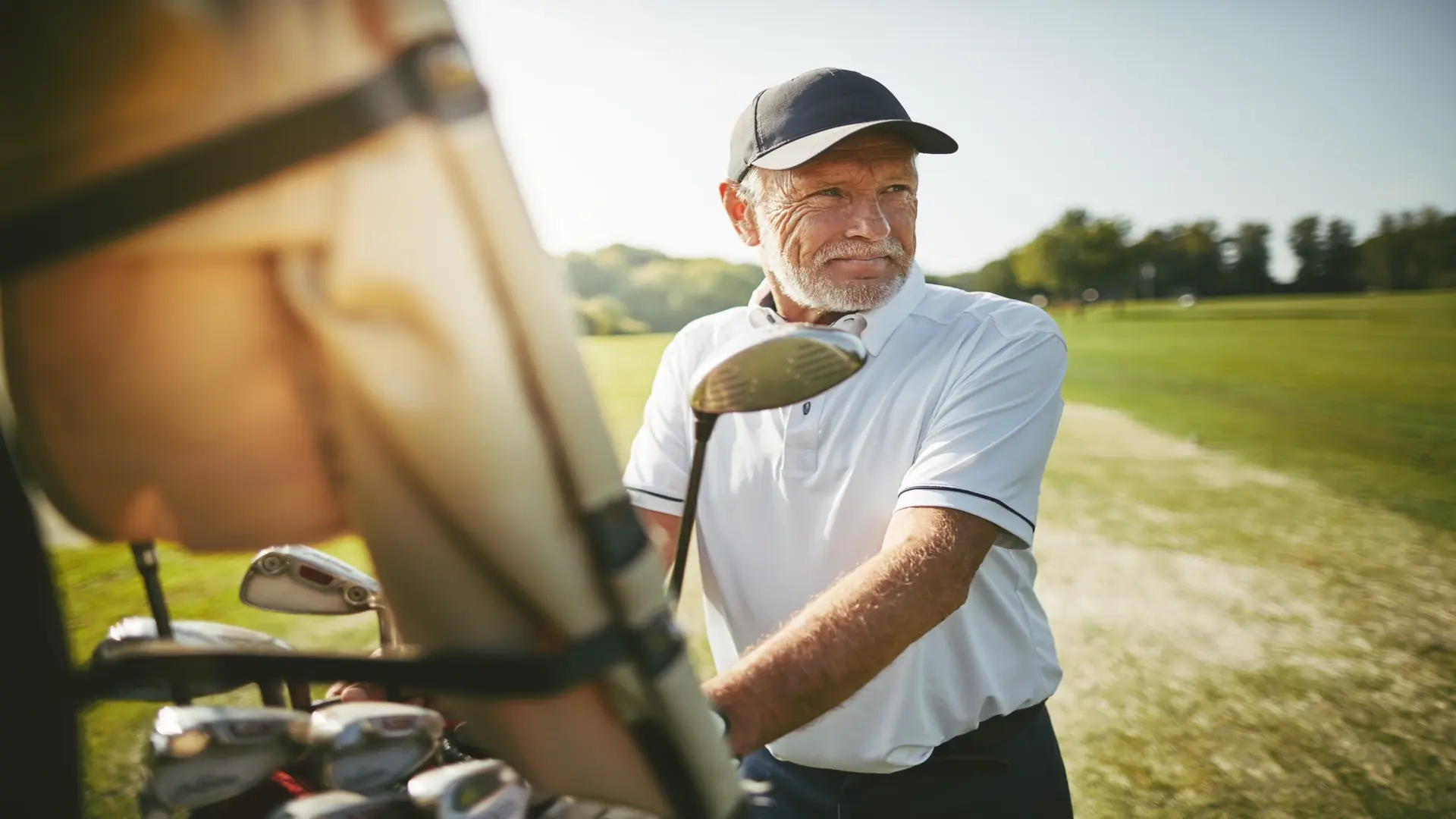 Man playing golf on a green, enjoying outdoor sports