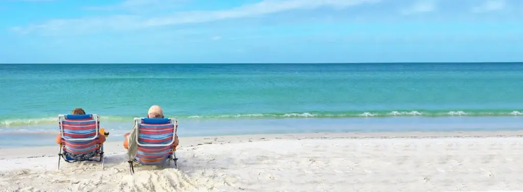 Couple enjoying the ocean views, symbolising the psychological impact of downsizing and embracing a new chapter in life.